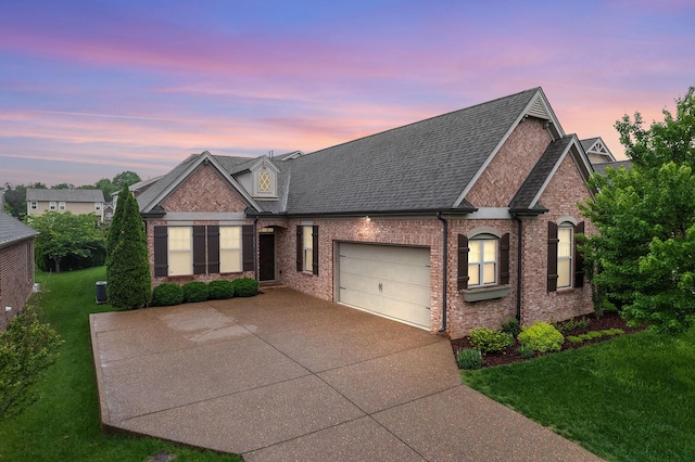 1740 Hartford Ln, Mount Juliet, TN 37122 - view of front facade featuring concrete driveway, a garage, brick siding, and a lawn