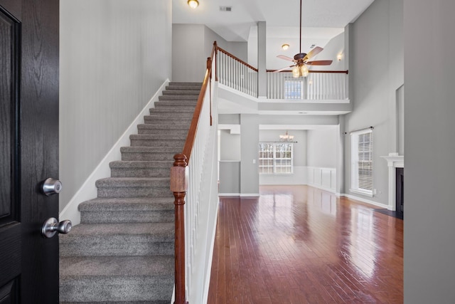 602 Pemberton Ct, Mount Juliet, TN 37122 - stairs with a ceiling fan, hardwood / wood-style floors, a high ceiling, a fireplace with flush hearth, and a chandelier