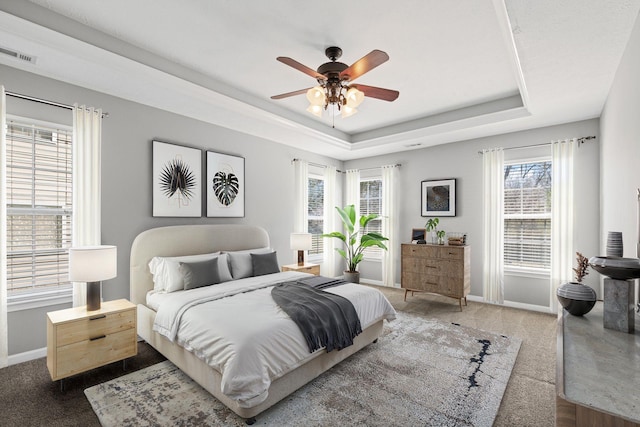 602 Pemberton Ct, Mount Juliet, TN 37122 - bedroom featuring a tray ceiling, baseboards, multiple windows, and a ceiling fan