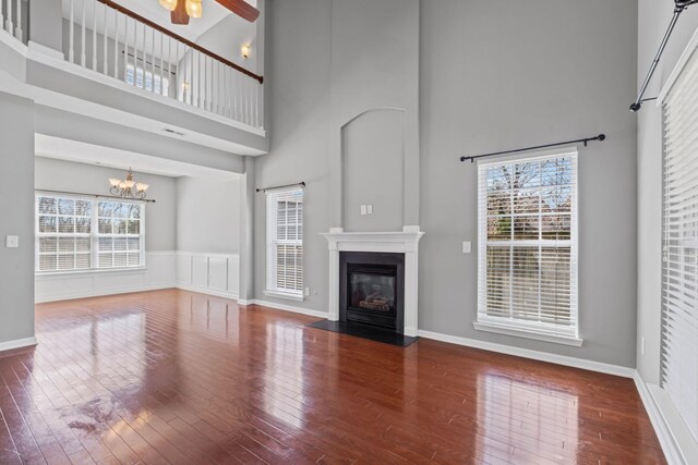 602 Pemberton Ct, Mount Juliet, TN 37122 - unfurnished living room with a high ceiling, a chandelier, hardwood / wood-style floors, a fireplace with flush hearth, and plenty of natural light