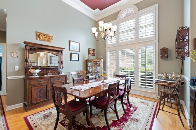 500 Forrest Park Cir, Franklin, TN 37064 - dining room with crown molding, a towering ceiling, a chandelier, and light wood-type flooring