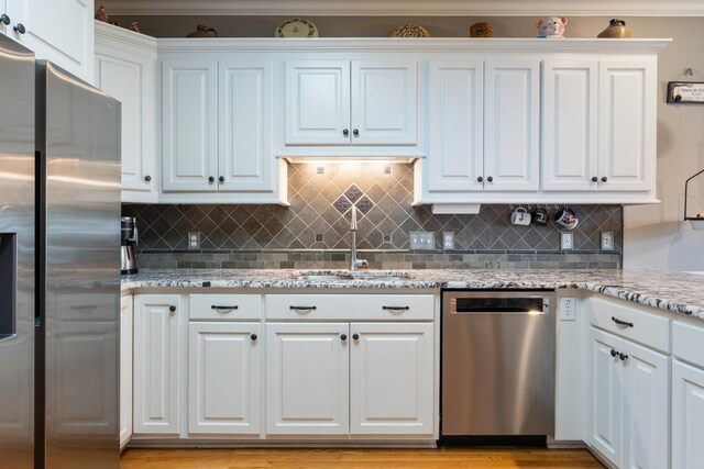 500 Forrest Park Cir, Franklin, TN 37064 - kitchen featuring stainless steel appliances, white cabinetry, tasteful backsplash, and light stone countertops