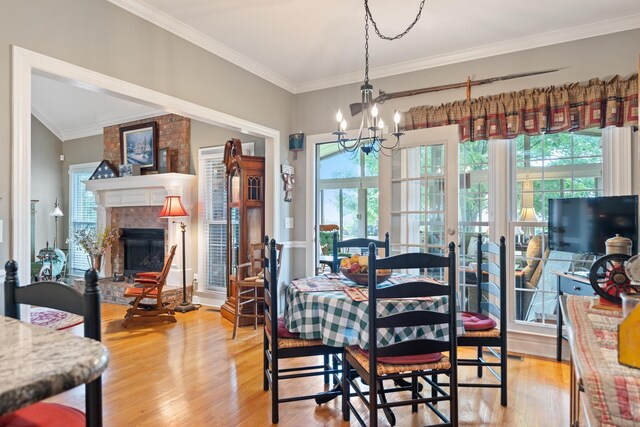 500 Forrest Park Cir, Franklin, TN 37064 - dining area featuring healthy amount of natural light, a chandelier, light wood finished floors, ornamental molding, and a fireplace