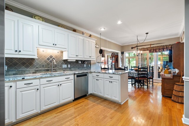 500 Forrest Park Cir, Franklin, TN 37064 - kitchen with stainless steel dishwasher, a peninsula, light wood-style flooring, white cabinetry, and decorative backsplash