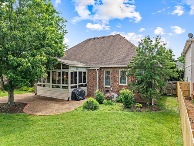 500 Forrest Park Cir, Franklin, TN 37064 - rear view of house with a sunroom, a shingled roof, brick siding, and a patio