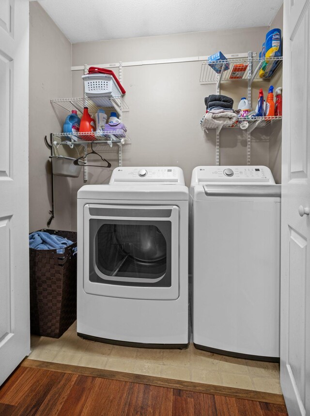 114 Silver Leaf Cir, Dickson, TN 37055 - washroom featuring washer and clothes dryer and wood finished floors
