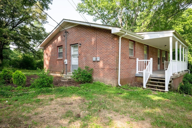 7703 Horn Tavern Rd, Fairview, TN 37062 - view of side of home with entry steps, brick siding, and a porch