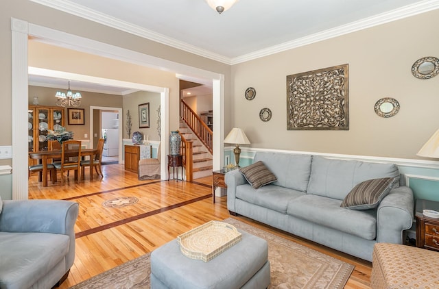 673 Newton Ln, Gallatin, TN 37066 - living room with a chandelier, stairway, crown molding, and light wood-style floors