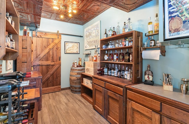 673 Newton Ln, Gallatin, TN 37066 - bar featuring a barn door, light wood finished floors, and an ornate ceiling