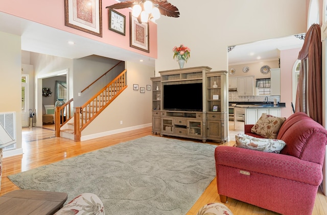 673 Newton Ln, Gallatin, TN 37066 - living room featuring light wood finished floors, stairs, ornamental molding, ceiling fan, and recessed lighting