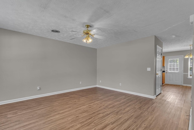 1512 Center Pointe Dr, Murfreesboro, TN 37130 - empty room with a textured ceiling, wood finished floors, a ceiling fan, baseboards, and a chandelier