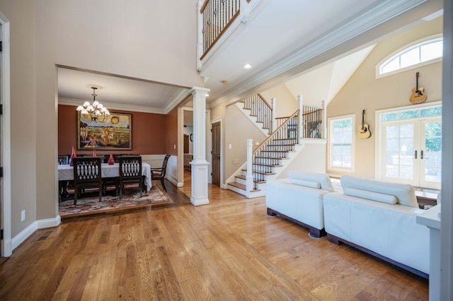 872 Pinnacle Hill Rd, Kingston Springs, TN 37082 - living room featuring a high ceiling, crown molding, stairway, light wood-type flooring, and a chandelier