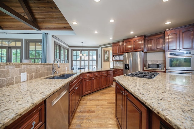 872 Pinnacle Hill Rd, Kingston Springs, TN 37082 - kitchen with appliances with stainless steel finishes, recessed lighting, backsplash, light stone counters, and light wood finished floors