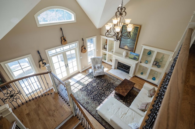 872 Pinnacle Hill Rd, Kingston Springs, TN 37082 - living room featuring wood finished floors, high vaulted ceiling, a chandelier, and a fireplace