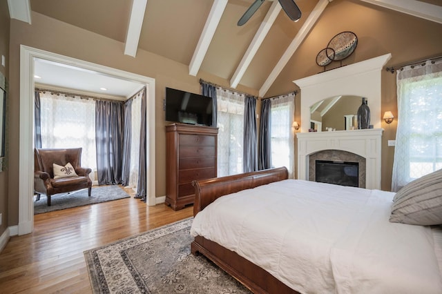 872 Pinnacle Hill Rd, Kingston Springs, TN 37082 - bedroom with a glass covered fireplace, multiple windows, and light wood finished floors
