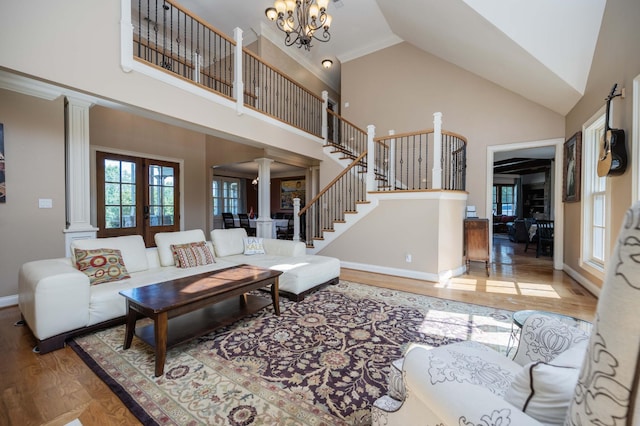 872 Pinnacle Hill Rd, Kingston Springs, TN 37082 - living room with ornate columns, high vaulted ceiling, wood finished floors, stairway, and a chandelier