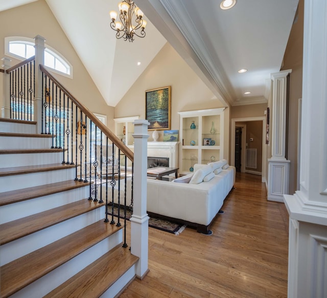 872 Pinnacle Hill Rd, Kingston Springs, TN 37082 - stairs with a fireplace, wood finished floors, a chandelier, recessed lighting, and ornamental molding