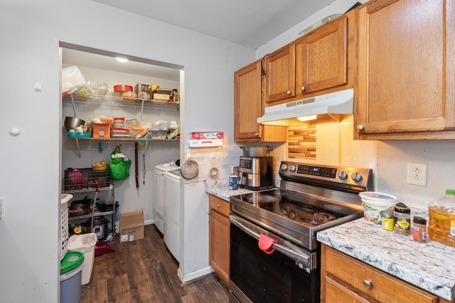 4145 Providence Park Ln, Nashville, TN 37211 - kitchen with stainless steel electric stove, under cabinet range hood, separate washer and dryer, dark wood-style floors, and brown cabinets