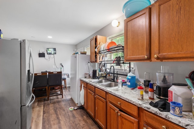 4145 Providence Park Ln, Nashville, TN 37211 - kitchen featuring stainless steel fridge with ice dispenser, a sink, dark wood finished floors, brown cabinets, and recessed lighting