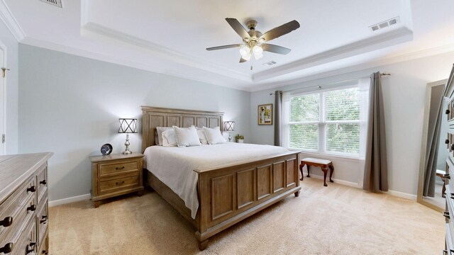 2809 Kaye Dr, Thompsons Station, TN 37179 - bedroom featuring a tray ceiling, ornamental molding, light colored carpet, and a ceiling fan