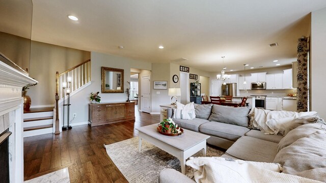 2809 Kaye Dr, Thompsons Station, TN 37179 - living area with a fireplace, stairway, dark wood finished floors, recessed lighting, and a chandelier
