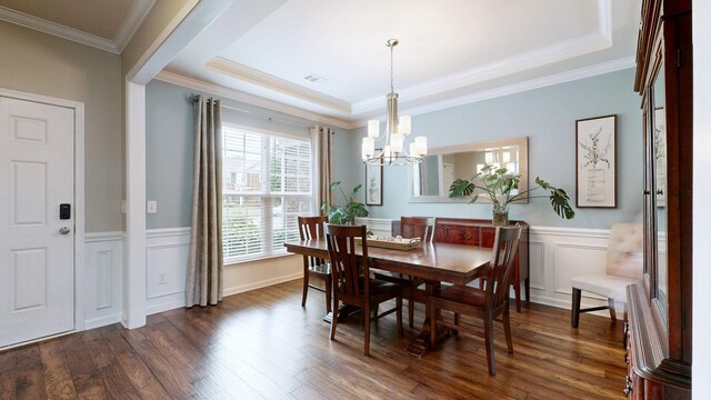 2809 Kaye Dr, Thompsons Station, TN 37179 - dining area featuring a chandelier, dark wood finished floors, wainscoting, ornamental molding, and a raised ceiling