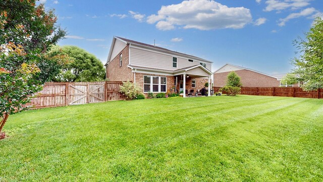 2809 Kaye Dr, Thompsons Station, TN 37179 - back of property featuring brick siding, a fenced backyard, and a patio area