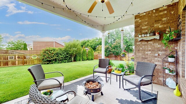 2809 Kaye Dr, Thompsons Station, TN 37179 - fenced backyard with a fire pit, ceiling fan, and a patio