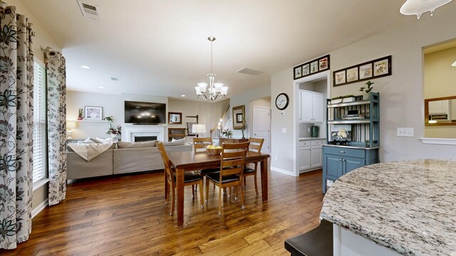 2809 Kaye Dr, Thompsons Station, TN 37179 - dining room with dark wood-style floors, a fireplace, a chandelier, and recessed lighting