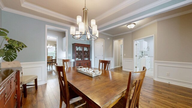 2809 Kaye Dr, Thompsons Station, TN 37179 - dining space featuring a chandelier, dark wood-type flooring, wainscoting, ornamental molding, and a decorative wall