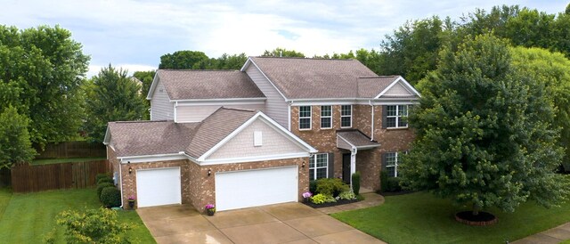 2809 Kaye Dr, Thompsons Station, TN 37179 - view of front of home featuring an attached garage, brick siding, concrete driveway, and roof with shingles