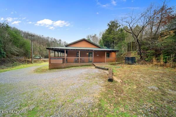 1999 E Mountain View Way, Sevierville, TN 37862 - rustic home with covered porch and gravel driveway