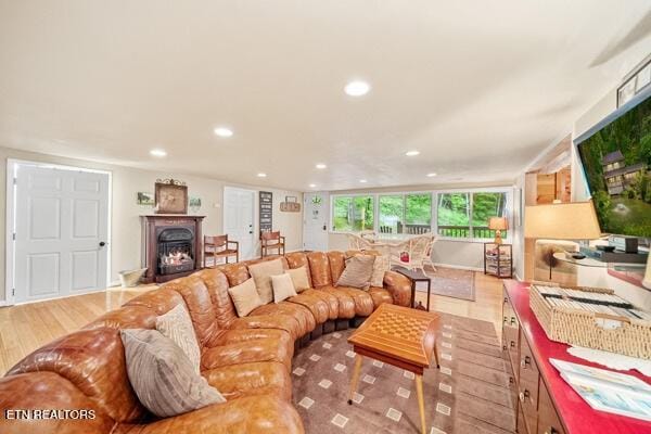 3127 Emerald Springs Loop, Sevierville, TN 37862 - living room with recessed lighting, wood finished floors, and a warm lit fireplace