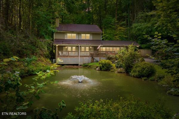 3127 Emerald Springs Loop, Sevierville, TN 37862 - rear view of property featuring a forest view, a chimney, and a wooden deck