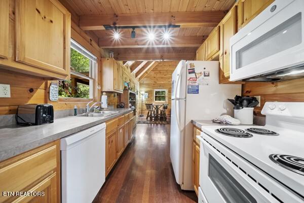 4196 Mountain Rest Way, Sevierville, TN 37876 - kitchen with white appliances, wooden ceiling with exposed beams, dark wood-style flooring, wooden walls, and light countertops
