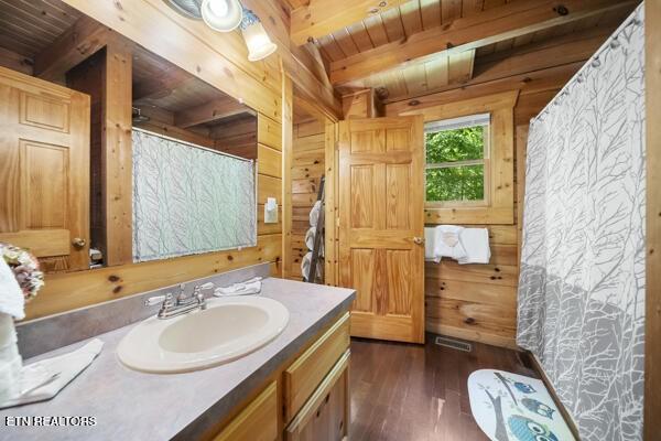 4196 Mountain Rest Way, Sevierville, TN 37876 - bathroom featuring wood walls, vanity, hardwood / wood-style flooring, wood ceiling with exposed beams, and curtained shower
