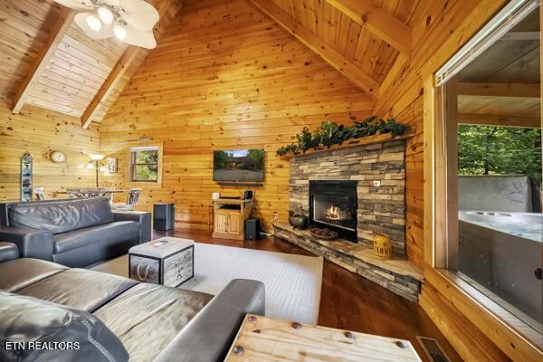 4196 Mountain Rest Way, Sevierville, TN 37876 - living room featuring wood ceiling, wood finished floors, wood walls, a fireplace, and healthy amount of natural light