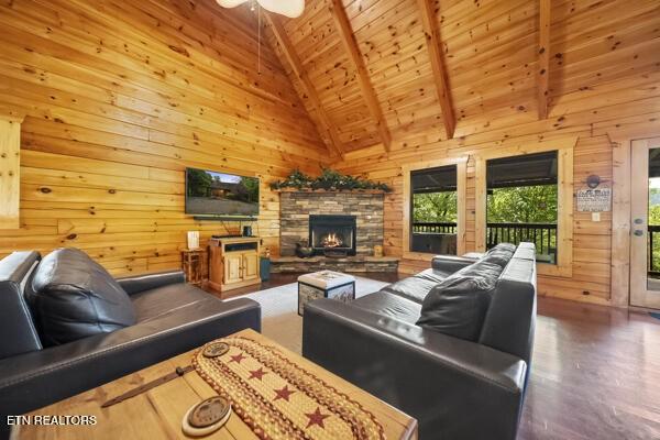 4196 Mountain Rest Way, Sevierville, TN 37876 - living area with wood walls, wood ceiling with exposed beams, wood finished floors, high vaulted ceiling, and a fireplace