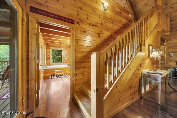 4196 Mountain Rest Way, Sevierville, TN 37876 - staircase with wooden walls, wood finished floors, vaulted ceiling, and wood ceiling
