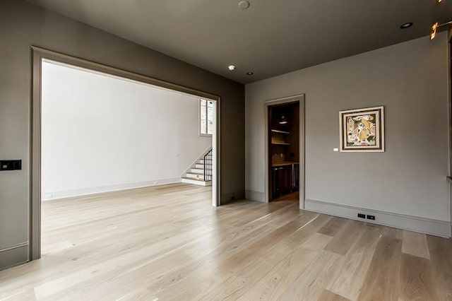 1302B Pillow St, Nashville, TN 37203 - unfurnished room featuring stairs, light wood-type flooring, and baseboards