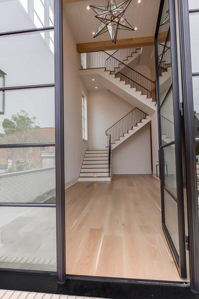 1302B Pillow St, Nashville, TN 37203 - foyer with wood finished floors, stairway, a towering ceiling, and a chandelier