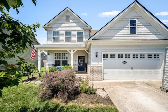 312 Whisper Wood Way, Lebanon, TN 37087 - view of front of property featuring concrete driveway, a porch, and a garage