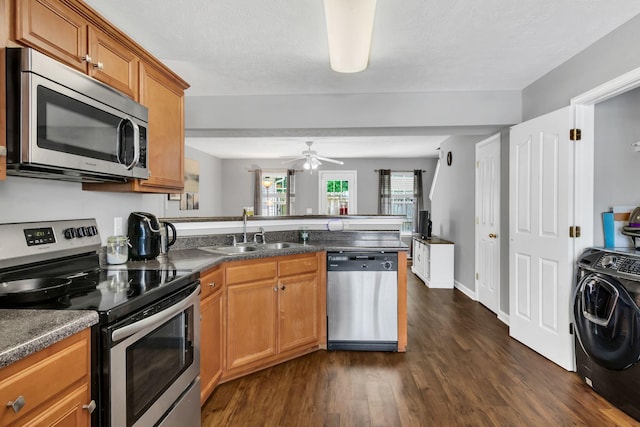 243 Shoshone Pl, Murfreesboro, TN 37128 - kitchen with appliances with stainless steel finishes, washer / clothes dryer, a peninsula, dark wood-style floors, and a ceiling fan