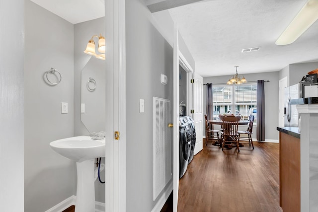 243 Shoshone Pl, Murfreesboro, TN 37128 - bathroom featuring washer and clothes dryer, a chandelier, and wood finished floors