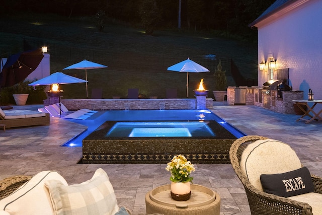 1024 Vaughn Crest Dr, Franklin, TN 37069 - pool at twilight featuring an outdoor kitchen, a patio, an in-ground hot tub, and an outdoor pool