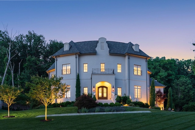 1024 Vaughn Crest Dr, Franklin, TN 37069 - french country inspired facade with french doors, a balcony, a front lawn, and stucco siding