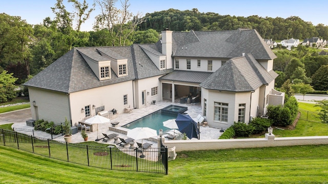 1024 Vaughn Crest Dr, Franklin, TN 37069 - rear view of property with stucco siding, a fenced backyard, a chimney, a patio, and a pool with connected hot tub