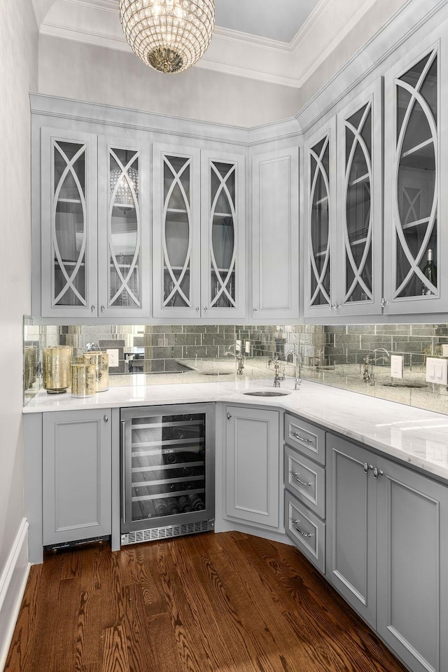 1024 Vaughn Crest Dr, Franklin, TN 37069 - indoor bar featuring beverage cooler, tasteful backsplash, ornamental molding, and dark wood-type flooring
