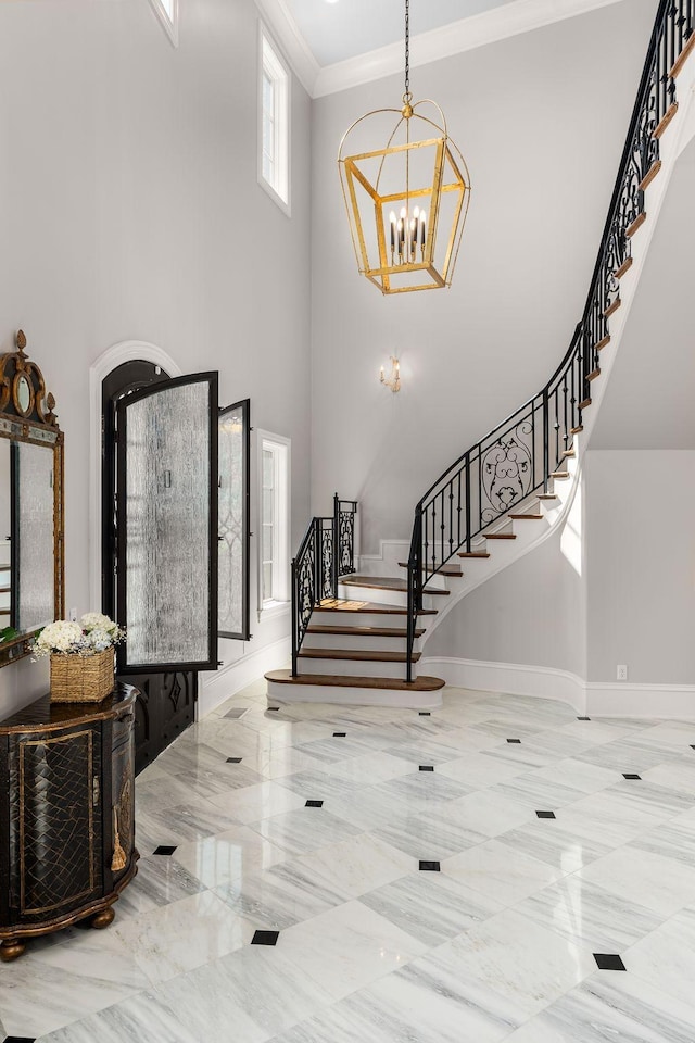 1024 Vaughn Crest Dr, Franklin, TN 37069 - foyer entrance with stairway, a chandelier, a high ceiling, and ornamental molding
