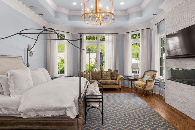 1024 Vaughn Crest Dr, Franklin, TN 37069 - bedroom featuring ornamental molding, wood finished floors, a chandelier, coffered ceiling, and a fireplace